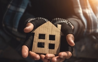 Hands Of Homelessness Poor Man Holding The Paper House Hope To H